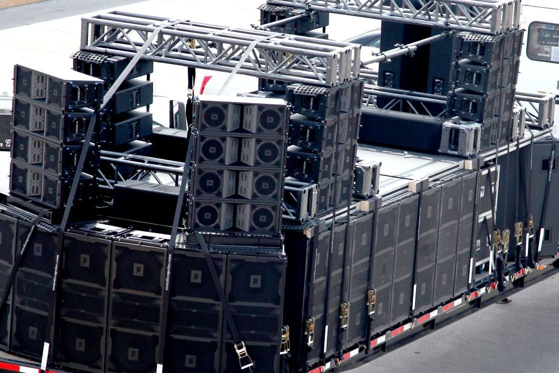 Line array cabinets and amplifier racks stacked and ready to fly